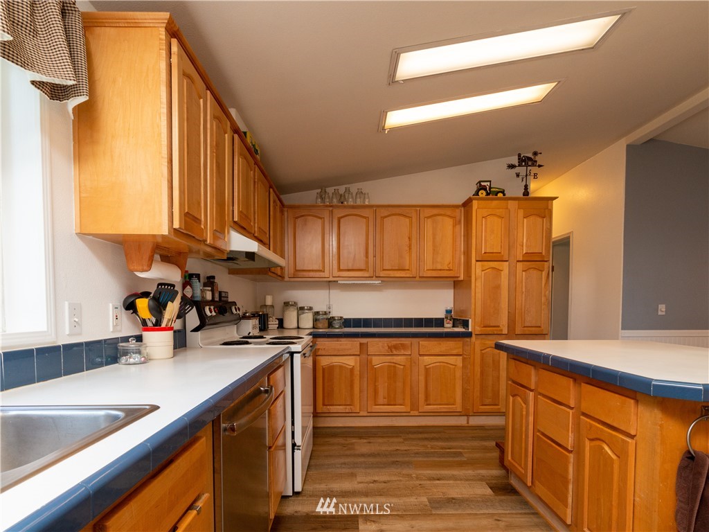 5004 186th Lane Southwest Rochester, WA 98579 - Photo 6 of 27 a kitchen with stainless steel appliances granite countertop a sink stove and cabinets