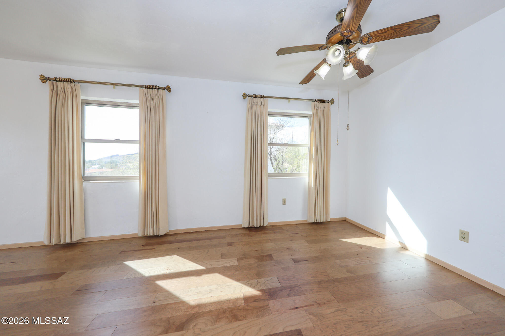 37 North Silverbell Road Tucson, AZ 85745 - Photo 12 of 31 an empty room with chandelier fan and windows