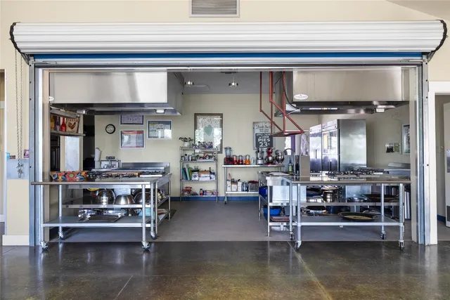 a kitchen with a table chairs and flat screen tv