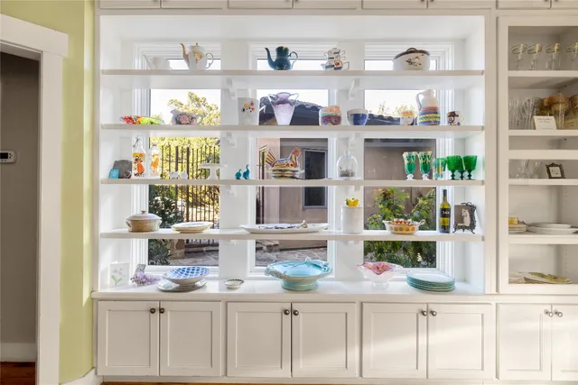 a kitchen with stainless steel appliances a table and chairs