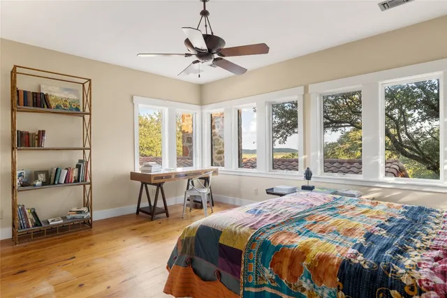 a bedroom with a large bed and a large window