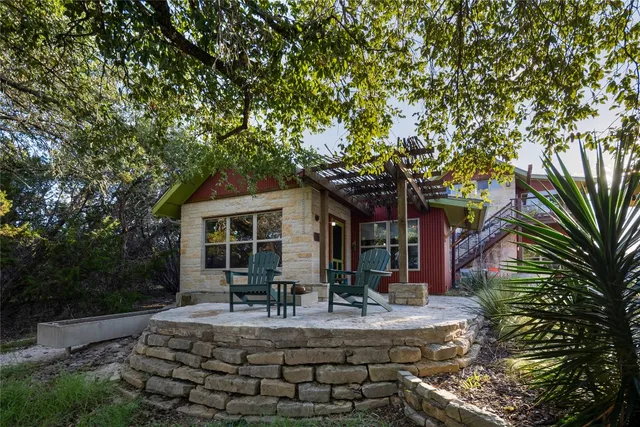a view of house with yard outdoor seating and tree
