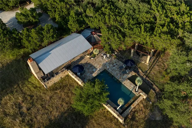 an aerial view of a house with a yard