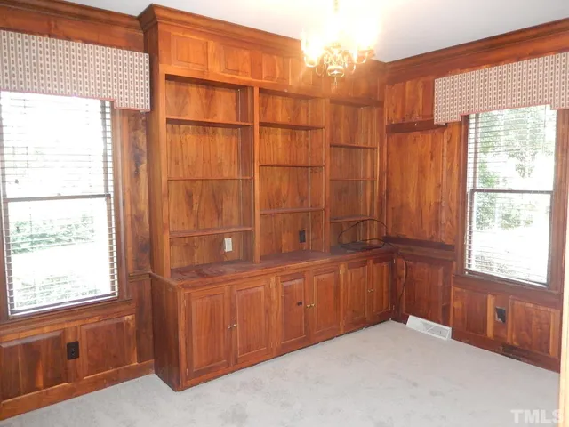 a view of a livingroom with a fireplace and window