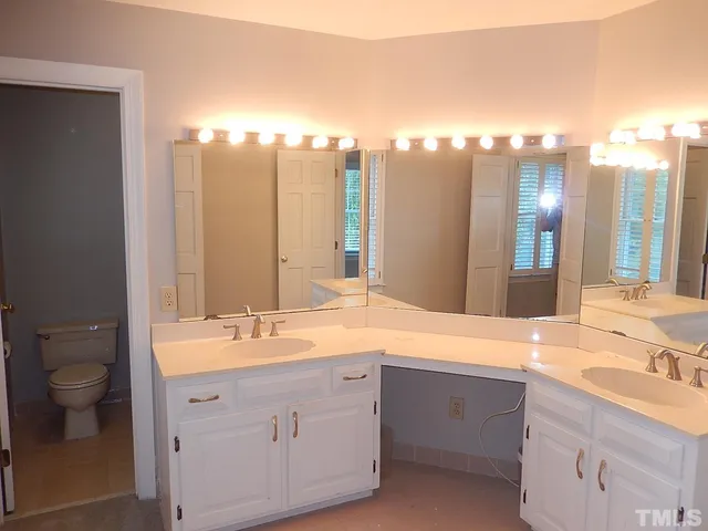 a bathroom with a double vanity sink and a mirror