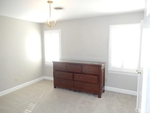 a bathroom with a granite countertop sink a toilet and a mirror