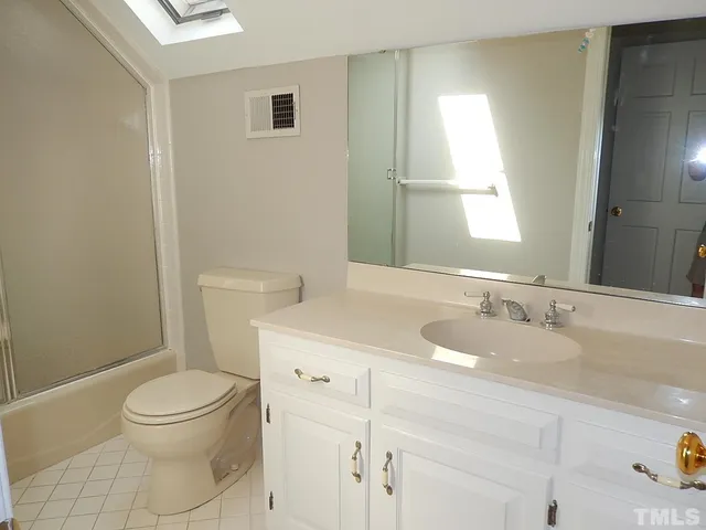 a bathroom with a glass shower door
