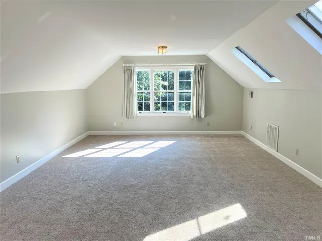 a view of a house with a backyard and a tree