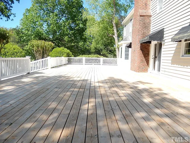 a view of beach and swimming pool with green space