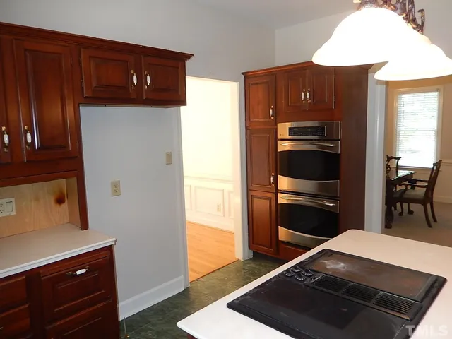 a kitchen with stainless steel appliances granite countertop a refrigerator and a stove