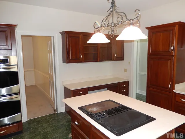 a kitchen with a sink a stove and a window