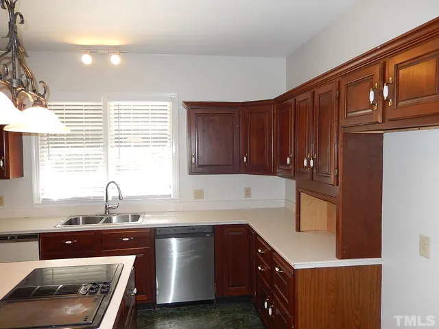 a kitchen with a sink cabinets and window