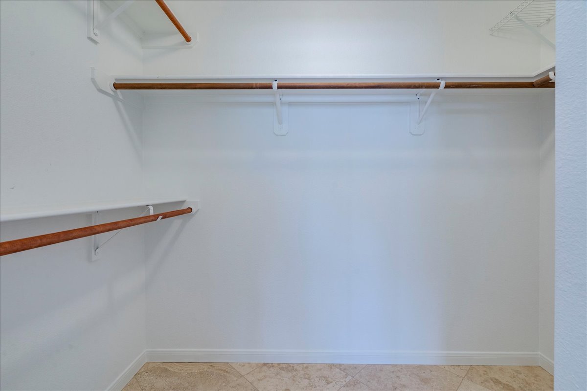 6530 Needham Lane Austin, TX 78739 - Photo 18 of 29 Ample hanging space and shelving define this bright, well-organized walk-in closet.