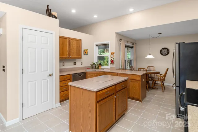 a kitchen that has a stove a sink and a refrigerator