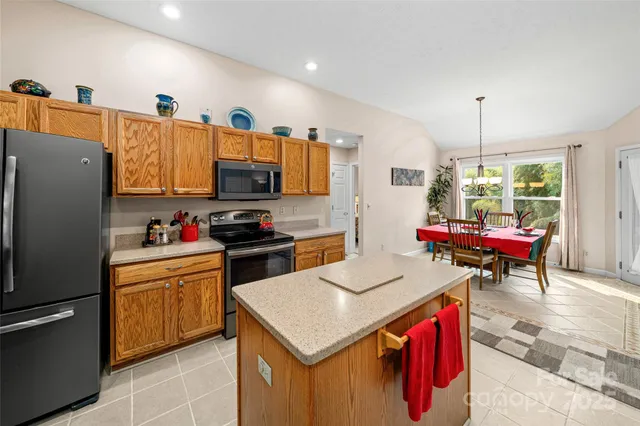a kitchen with a sink cabinets and wooden floor