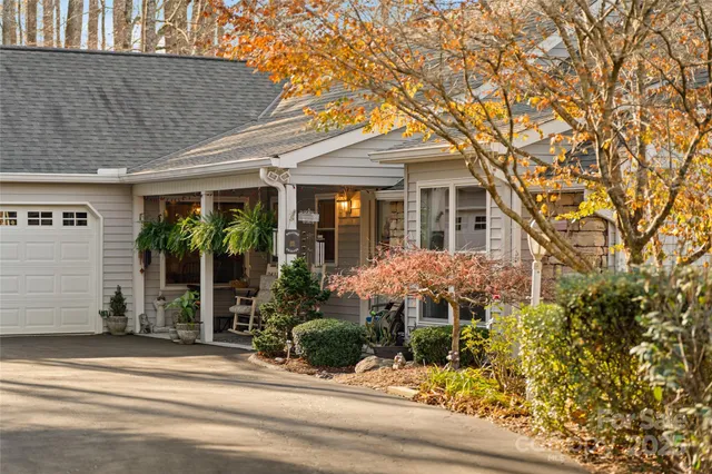 a view of a house with a yard and tree s