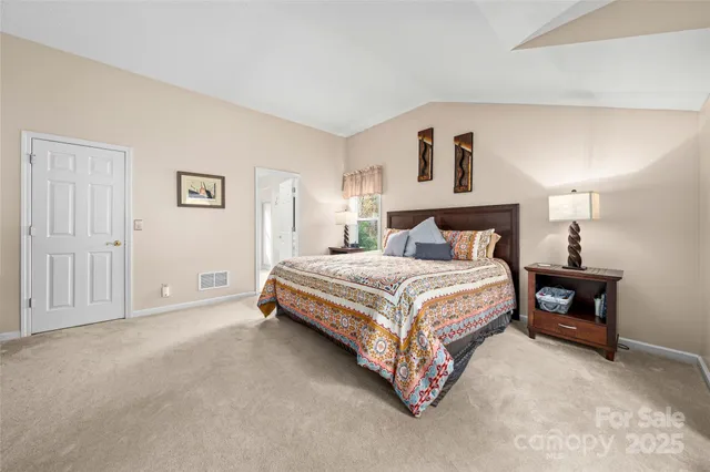 a en suite bathroom with a granite countertop sink and a mirror
