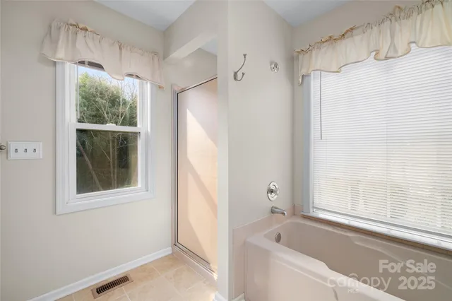a bedroom with a bed and a potted plant