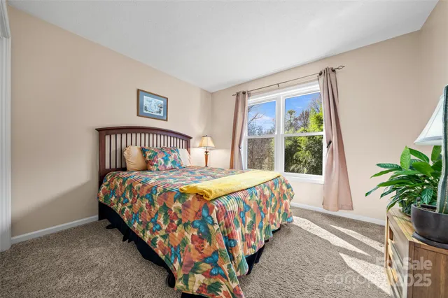 a bedroom with a bed and a lamp