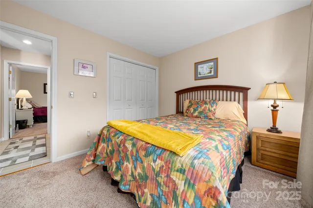 a bathroom with a granite countertop sink vanity mirror and toilet