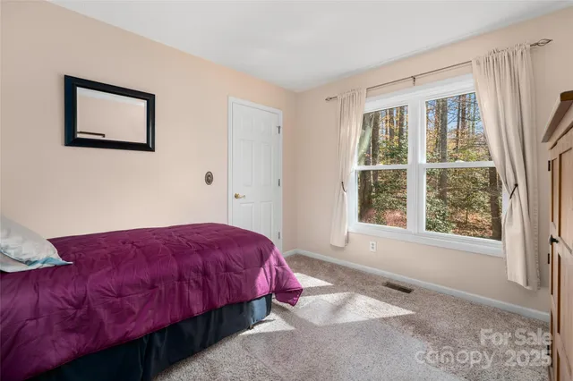 a bedroom with a bed and a night stand