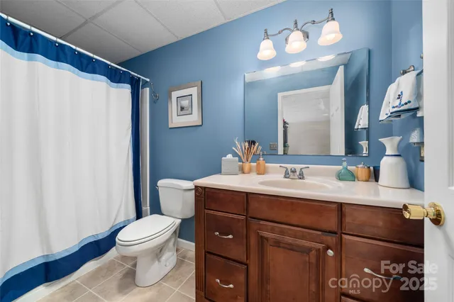 a kitchen with a sink cabinets and a chandelier