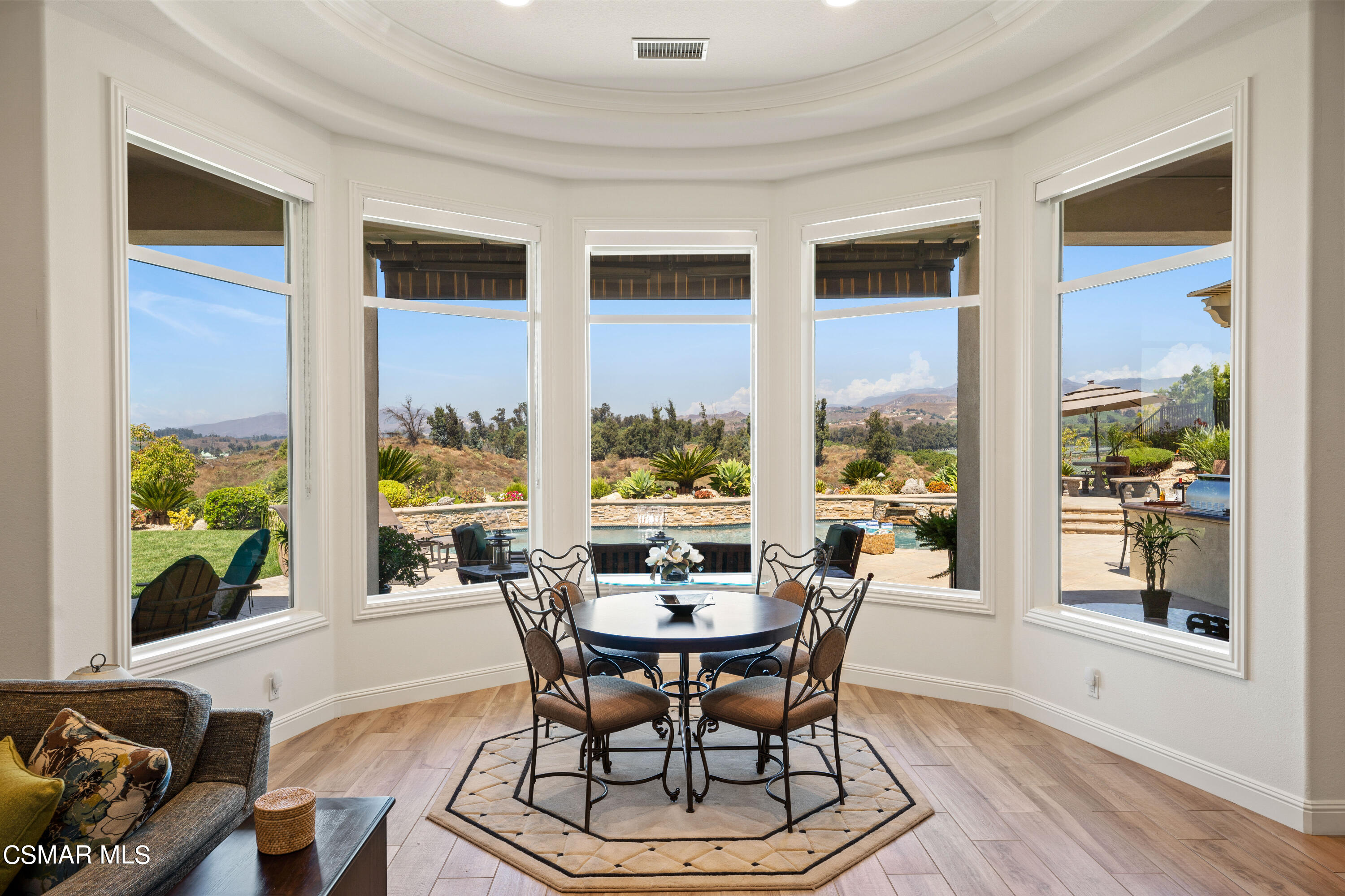 7343 Nicklaus Road Moorpark, CA 93021 - Photo 8 of 42 a dining room with furniture a chandelier and wooden floor