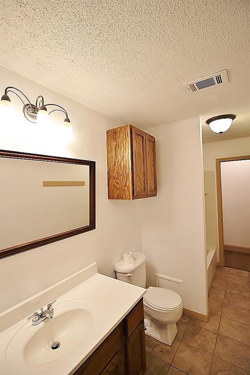 112 Trailwood Road Enchanted Oaks, TX 75156 - Photo 13 of 15 a bathroom with a sink a toilet and mirror