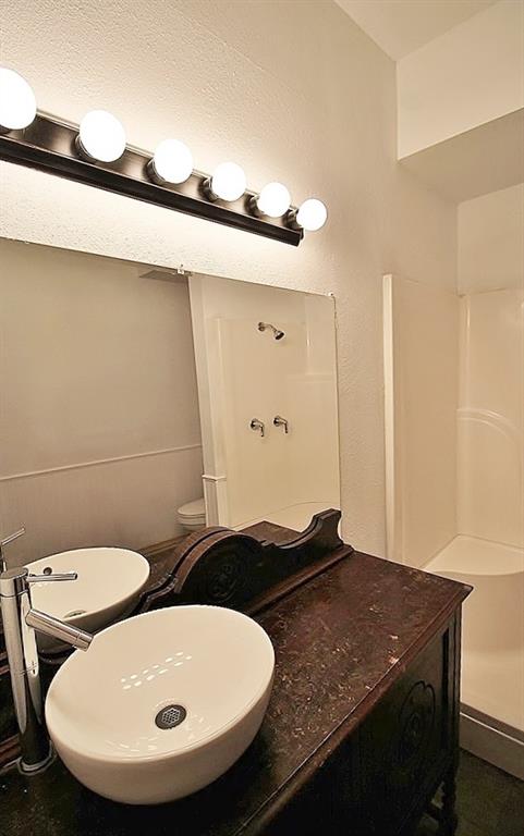 112 Trailwood Road Enchanted Oaks, TX 75156 - Photo 5 of 15 a bathroom with a granite countertop sink and a mirror