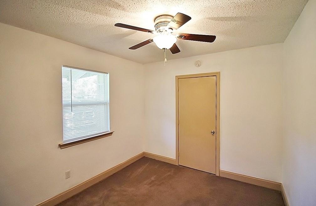 112 Trailwood Road Enchanted Oaks, TX 75156 - Photo 8 of 15 an empty room with a window and a fan