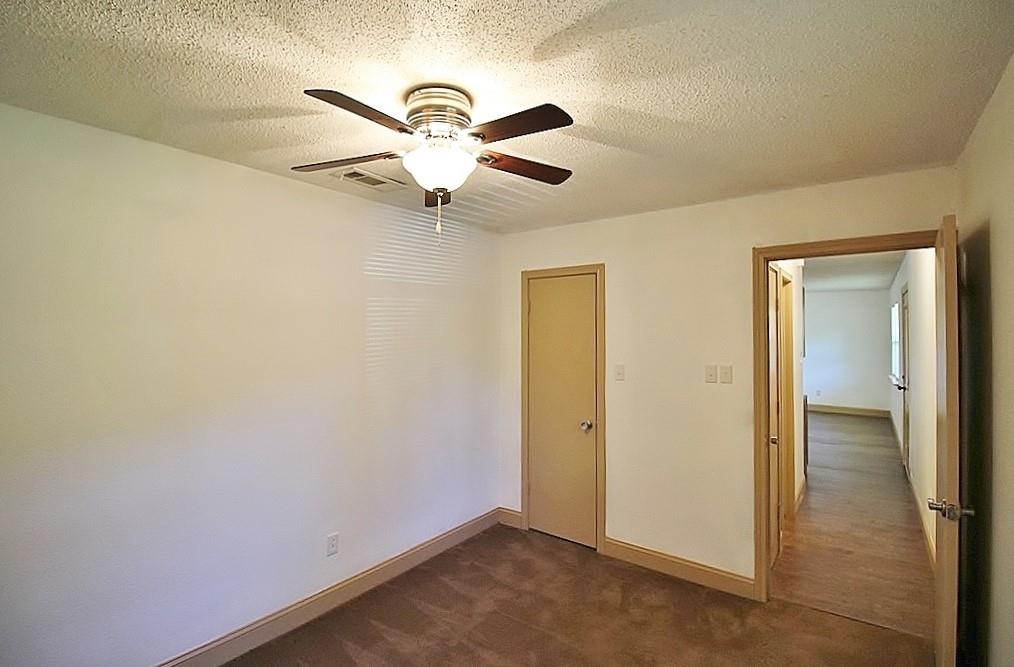 112 Trailwood Road Enchanted Oaks, TX 75156 - Photo 9 of 15 an empty room with a fan and a fan