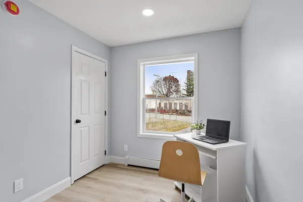a bedroom with a bed and a potted plant