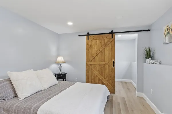 a bedroom with a bed and a chair