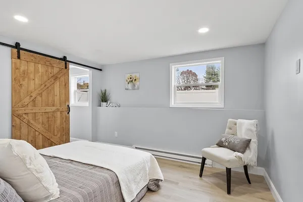 a bedroom with a bed and a chair