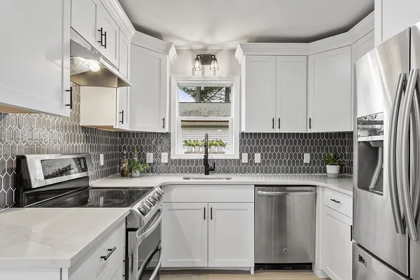 a kitchen with a sink stove and refrigerator