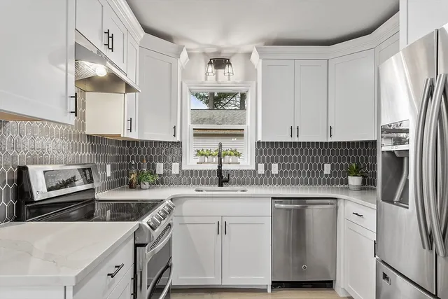 a kitchen with a sink stove and refrigerator