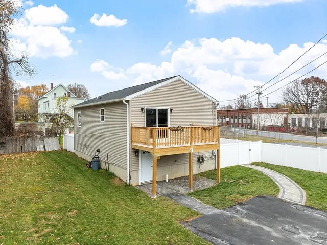 a view of a house with a backyard