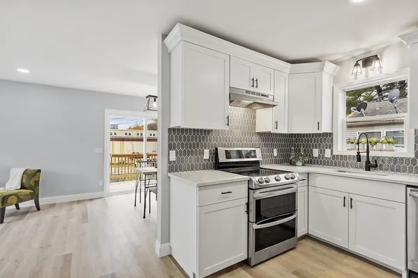 a kitchen with a sink a refrigerator and a stove