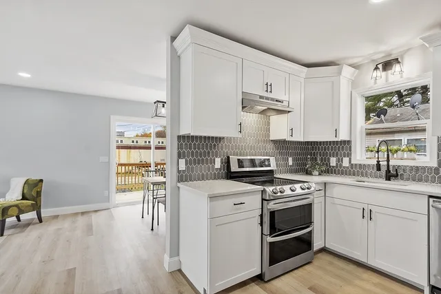 a kitchen with a sink a refrigerator and a stove