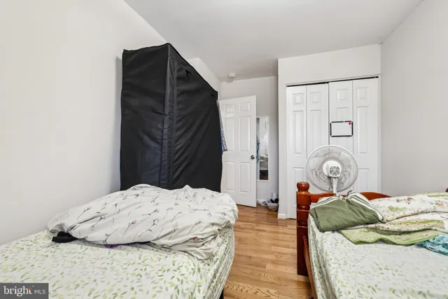 a bedroom with a bed and ceiling fan