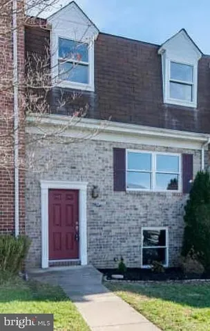 a stone house with a yard in front of it