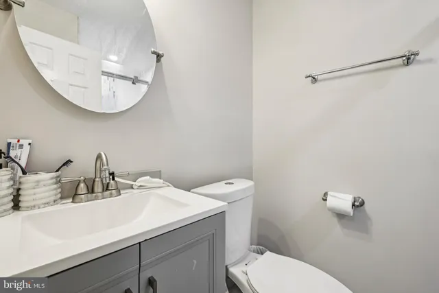 a bathroom with a toilet a sink and mirror