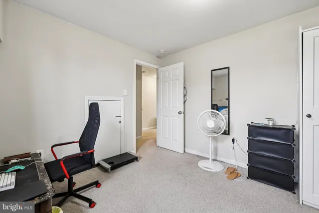 a view of a workspace with furniture and wooden floor