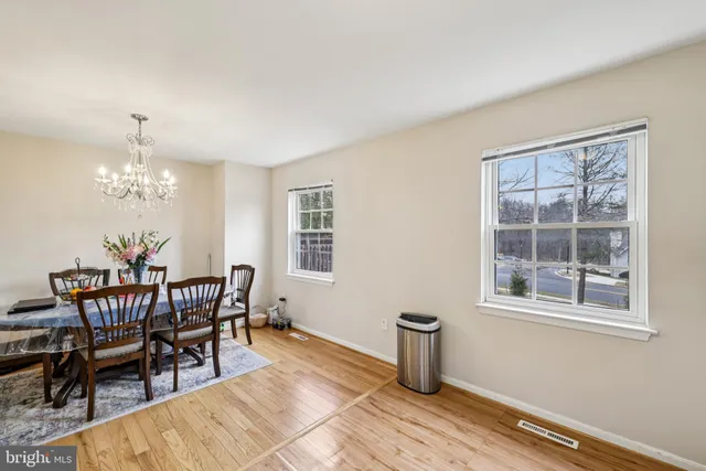 a view of a dining room with furniture and chandelier