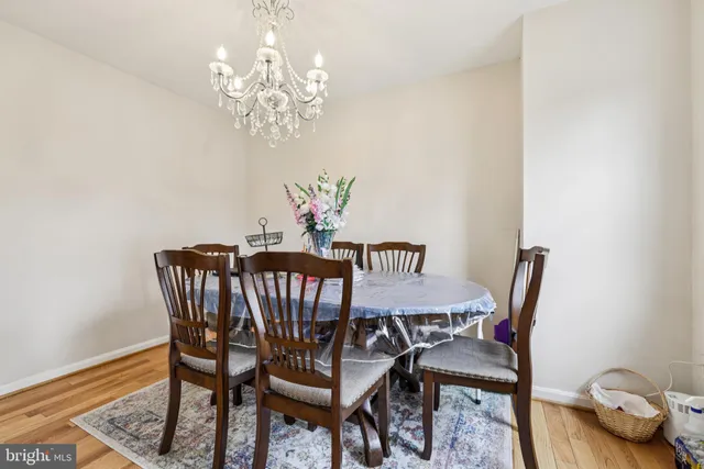 a view of a dining room with furniture and chandelier