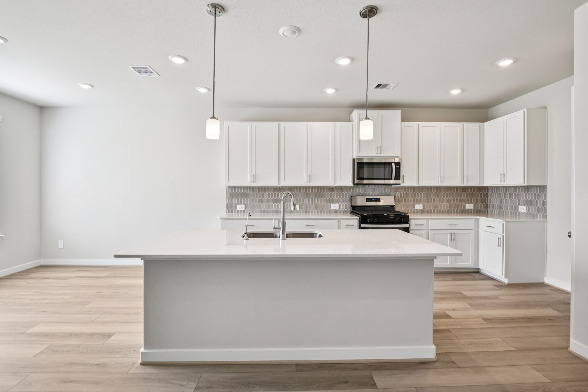 2843 Dark Lantern Drive Rosenberg, TX 77471 - Photo 1 of 49 a kitchen with kitchen island a sink stainless steel appliances and cabinets