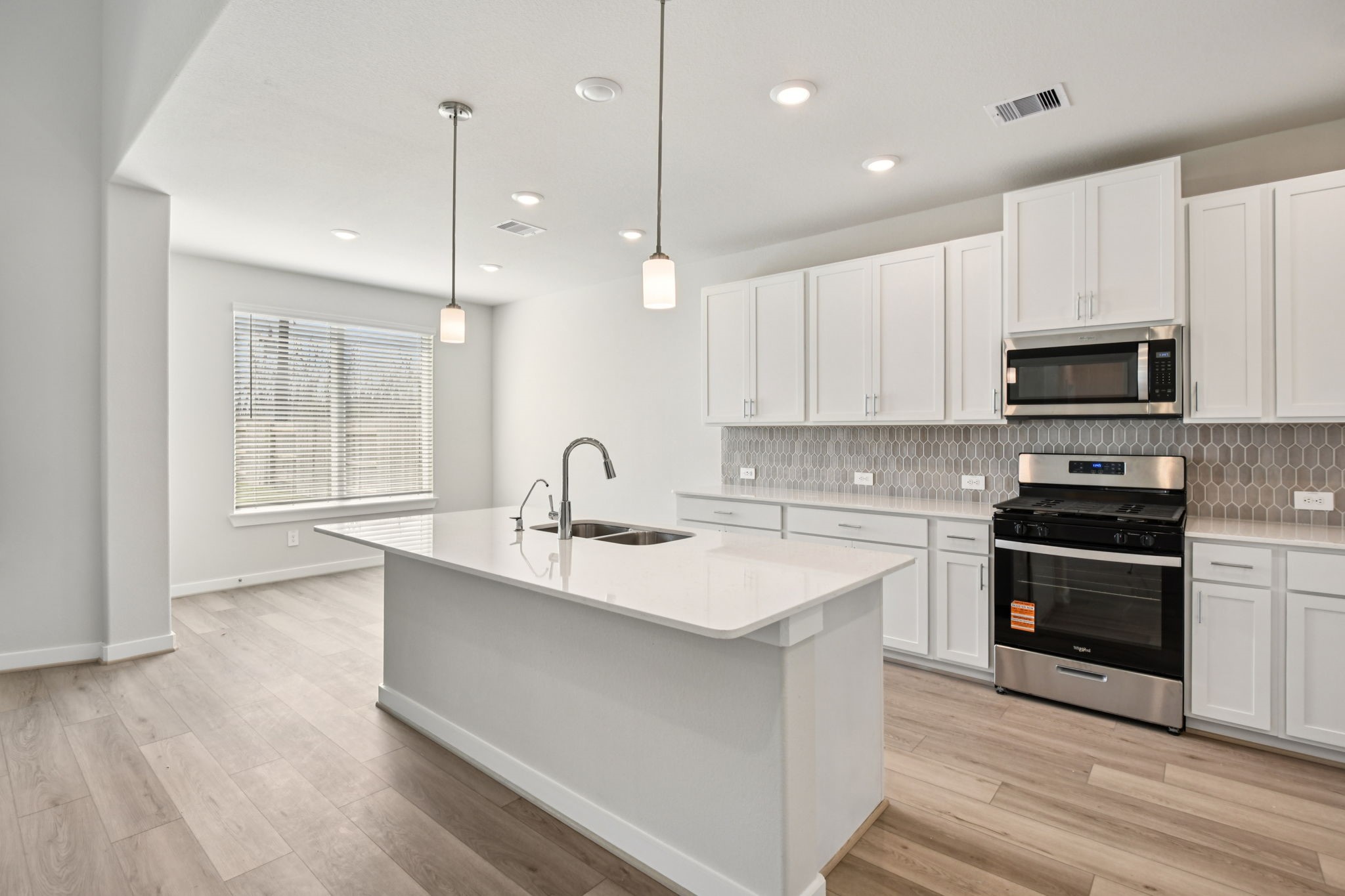 2843 Dark Lantern Drive Rosenberg, TX 77471 - Photo 2 of 49 a large kitchen with stainless steel appliances granite countertop a sink a stove a refrigerator and a microwave oven with white cabinets