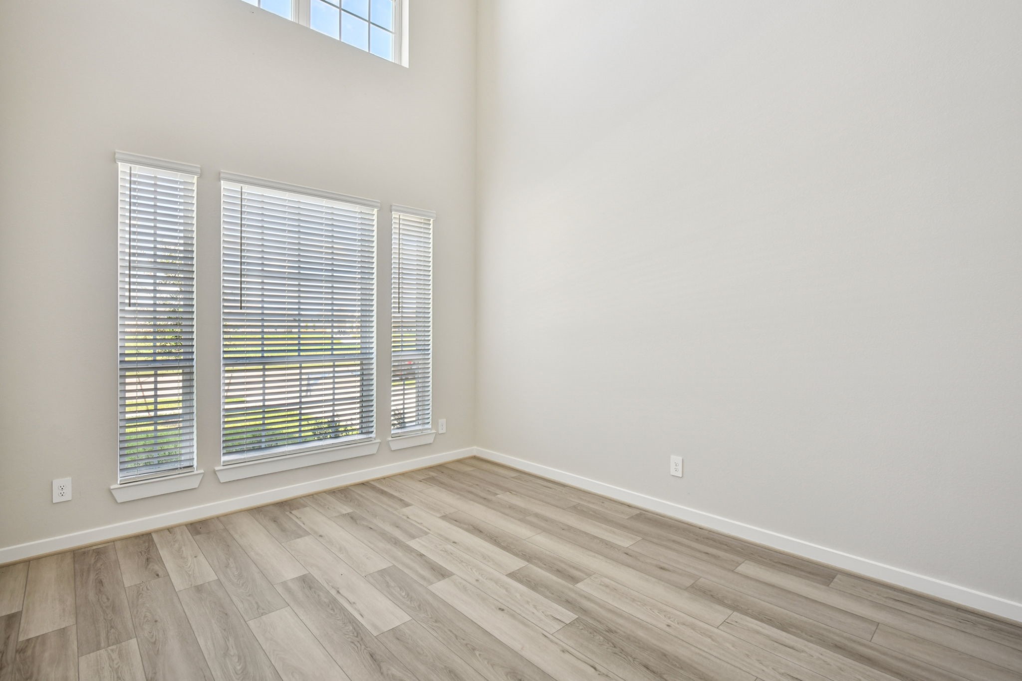 2843 Dark Lantern Drive Rosenberg, TX 77471 - Photo 21 of 49 a view of an empty room with wooden floor and a window