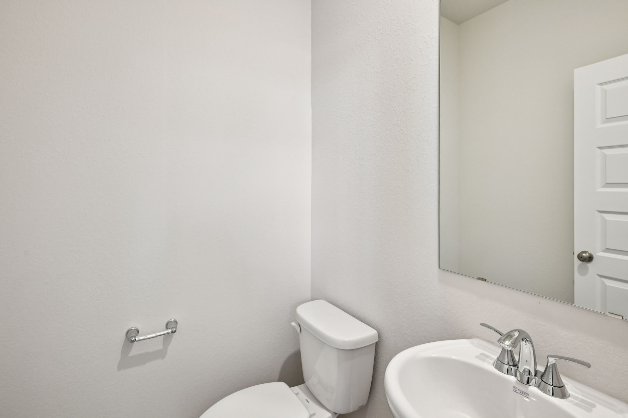 2843 Dark Lantern Drive Rosenberg, TX 77471 - Photo 23 of 49 a white toilet sitting next to a bathroom sink