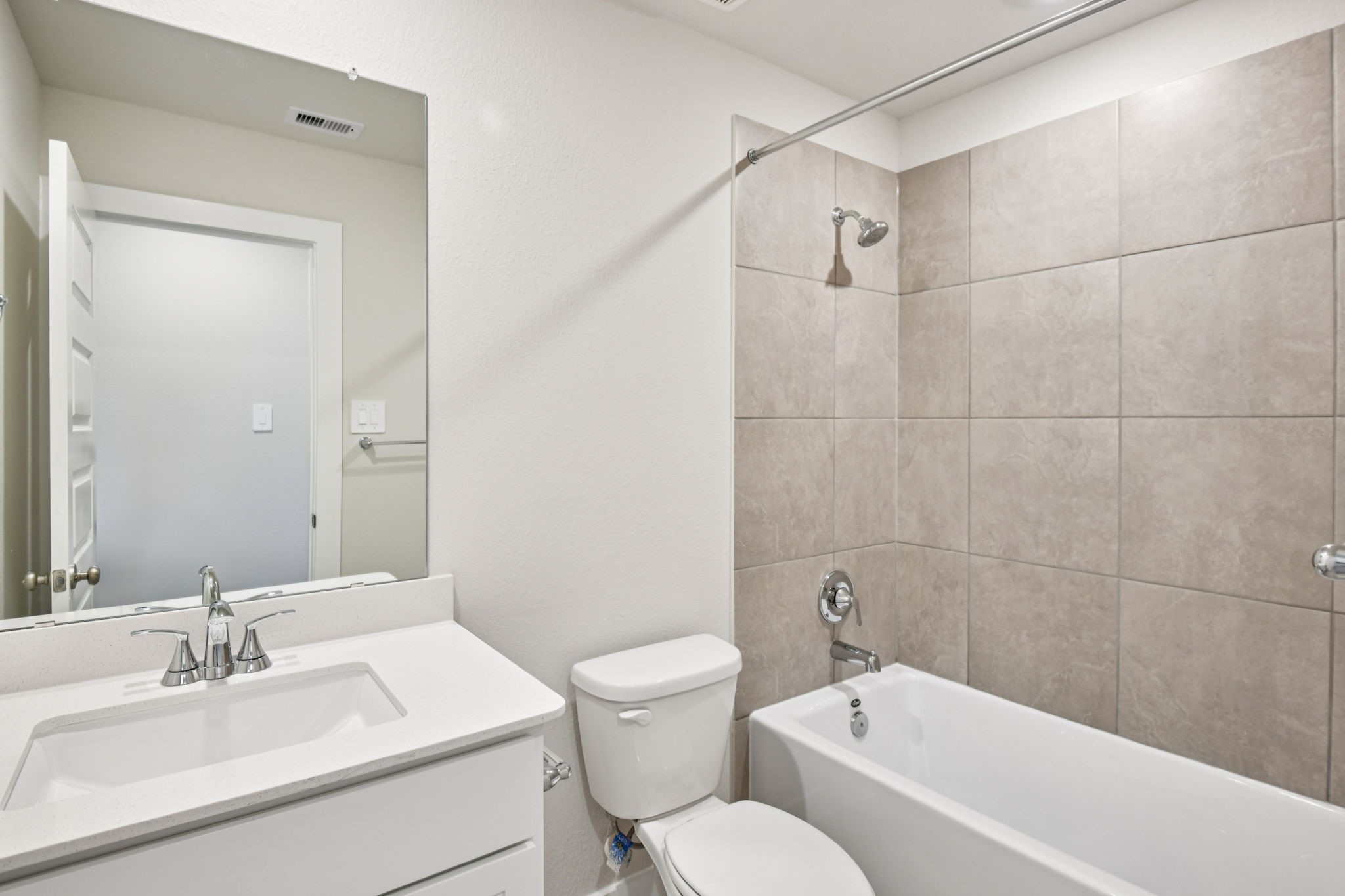 2843 Dark Lantern Drive Rosenberg, TX 77471 - Photo 39 of 49 a bathroom with a toilet a sink a mirror and bathtub